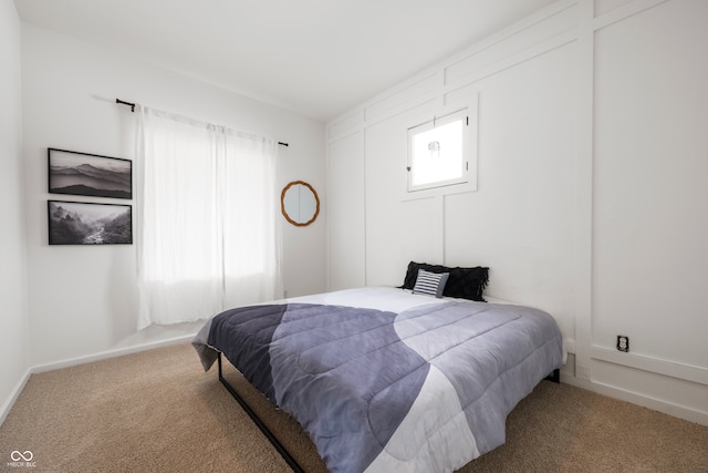 carpeted bedroom with multiple windows