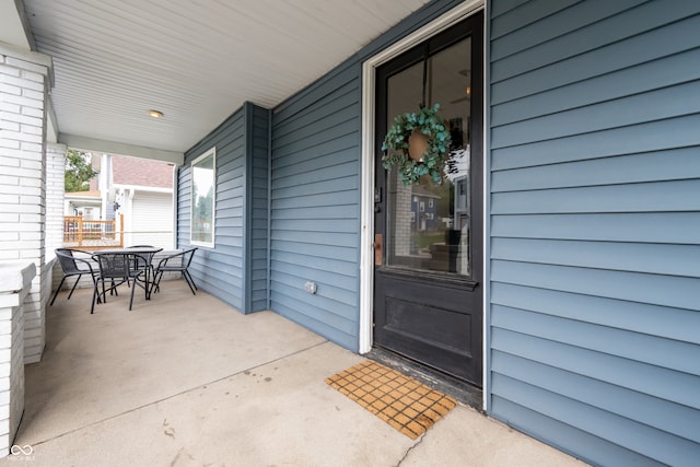 view of exterior entry featuring a porch