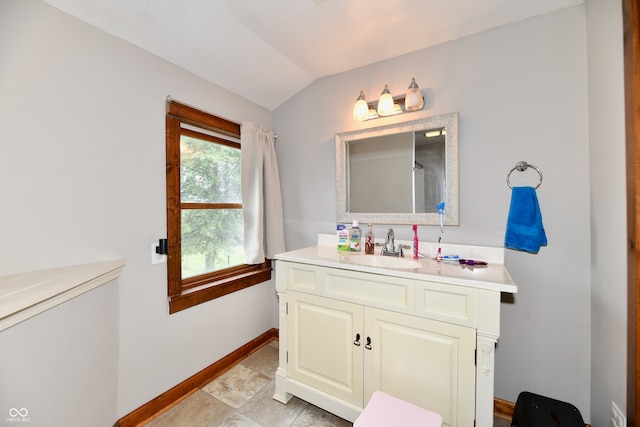 bathroom with vanity and lofted ceiling