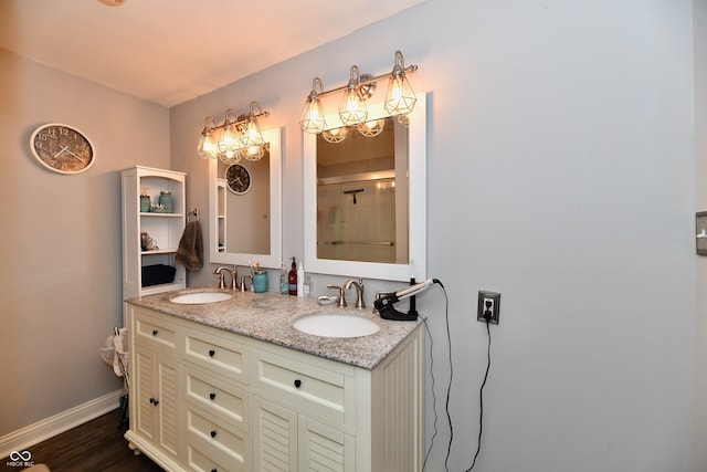 bathroom with walk in shower, vanity, and hardwood / wood-style flooring