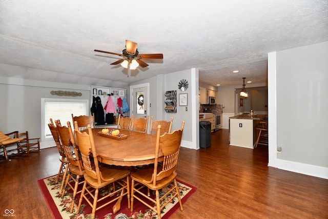 dining area featuring dark hardwood / wood-style flooring, a textured ceiling, and ceiling fan