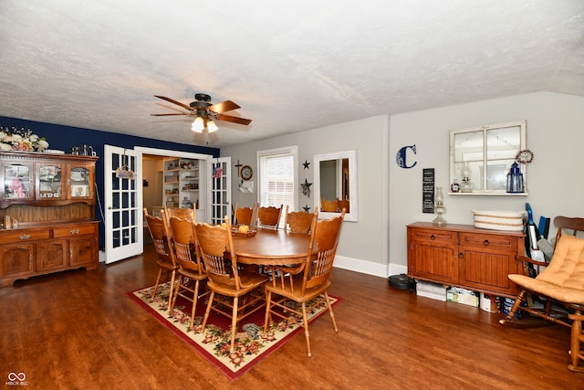 dining area featuring ceiling fan, dark hardwood / wood-style flooring, and a textured ceiling