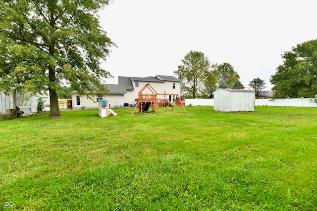 view of yard featuring a storage unit and a playground