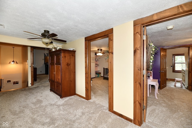 interior space with light colored carpet and a textured ceiling