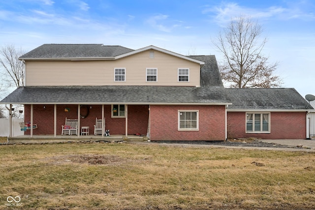 back of house featuring a lawn and a patio area