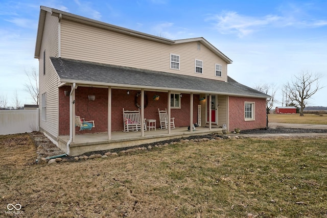 view of front of property featuring a front yard and a porch