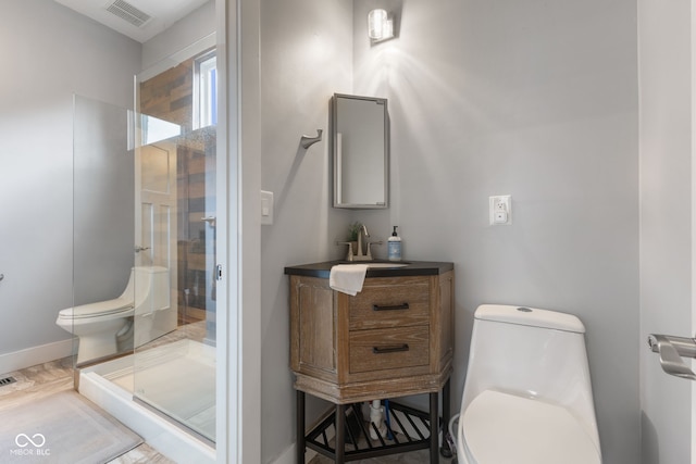 bathroom featuring walk in shower, vanity, and toilet