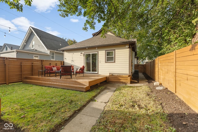 back of house with a lawn and a deck