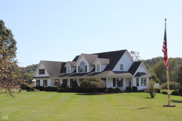 cape cod-style house featuring a front lawn