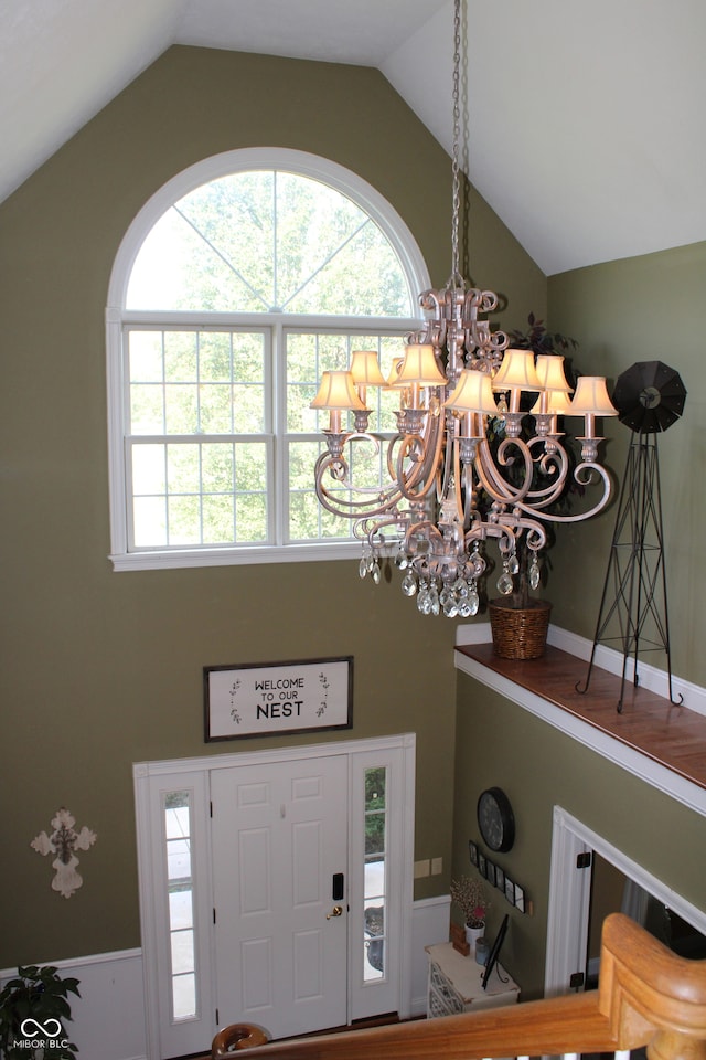 entrance foyer featuring a notable chandelier and lofted ceiling