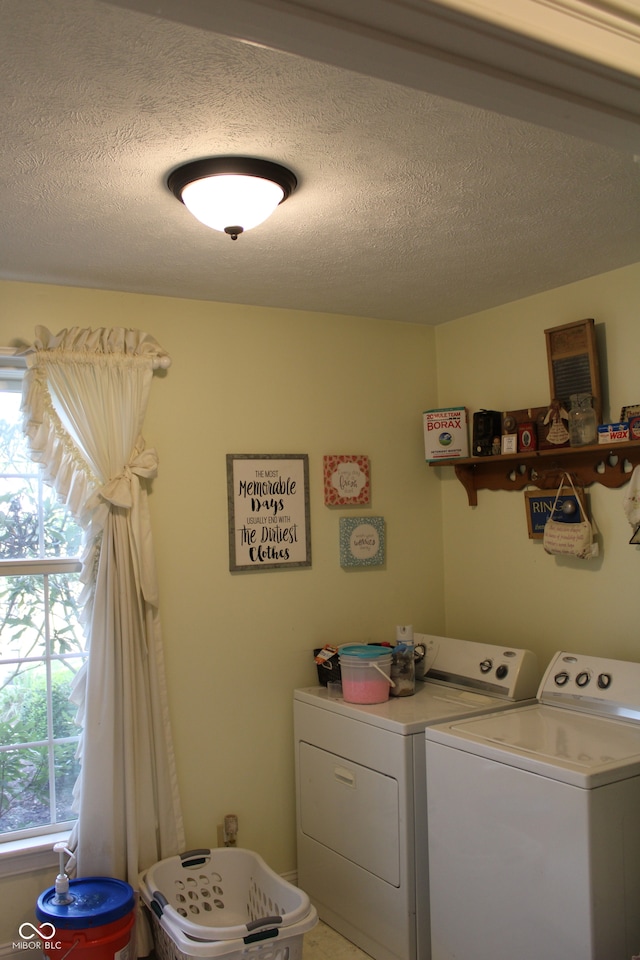 laundry room featuring a textured ceiling and separate washer and dryer