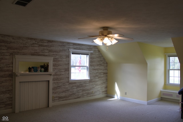 bonus room featuring vaulted ceiling, ceiling fan, and light colored carpet