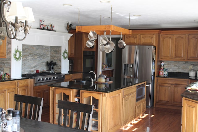 kitchen with appliances with stainless steel finishes, dark wood-type flooring, backsplash, crown molding, and sink