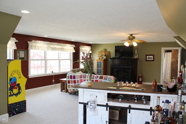 kitchen featuring ceiling fan and carpet flooring