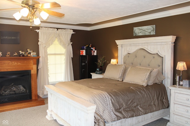 bedroom with ceiling fan, light carpet, and ornamental molding