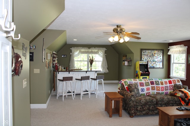 carpeted living room featuring lofted ceiling and ceiling fan