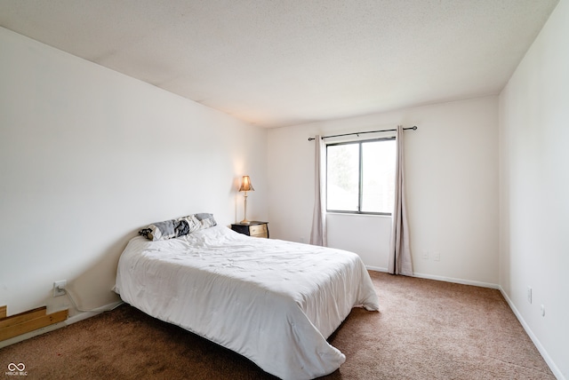 carpeted bedroom featuring a textured ceiling