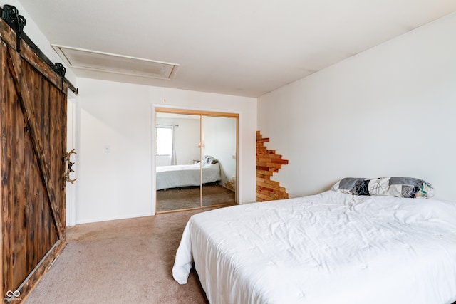 carpeted bedroom featuring a barn door