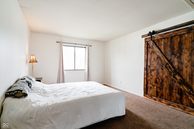 bedroom with carpet floors and a barn door