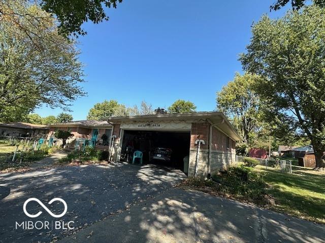 4434 E 46th St, Indianapolis, IN 46226 - view of home's exterior with an attached garage and driveway