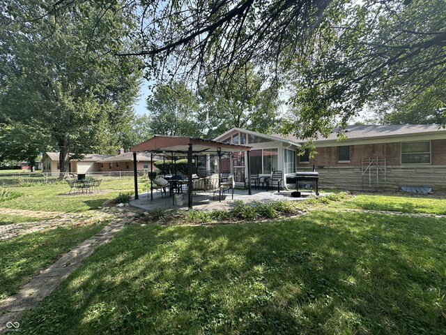 4434 E 46th St, Indianapolis, IN 46226 - back of property with fence, a patio area, a yard, and stone siding