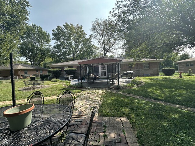4434 E 46th St, Indianapolis, IN 46226 - rear view of house featuring fence, a patio area, a yard, and outdoor dining space