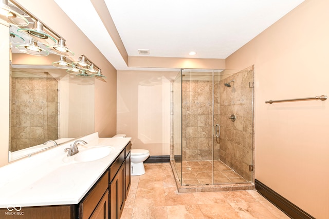 bathroom with a shower with shower door, vanity, and toilet