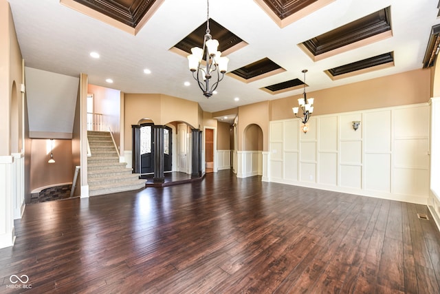 unfurnished living room featuring dark wood-type flooring, ornamental molding, beamed ceiling, and coffered ceiling