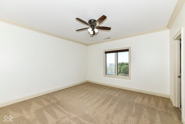 spare room featuring ornamental molding, carpet flooring, and ceiling fan