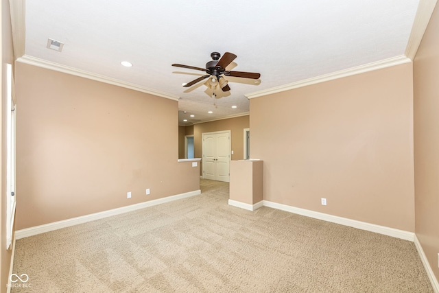 unfurnished room with ornamental molding, light colored carpet, and ceiling fan