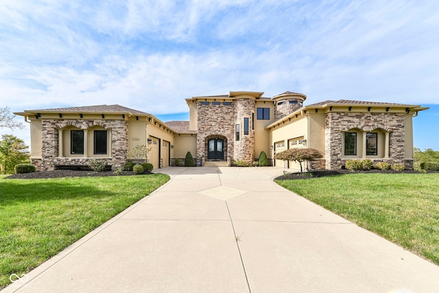 mediterranean / spanish home with a garage and a front yard