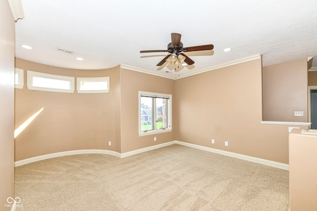 carpeted spare room with ornamental molding and ceiling fan