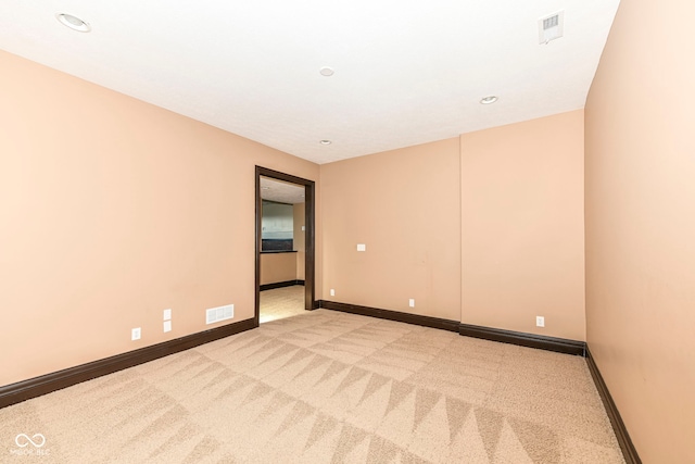 unfurnished room with light colored carpet