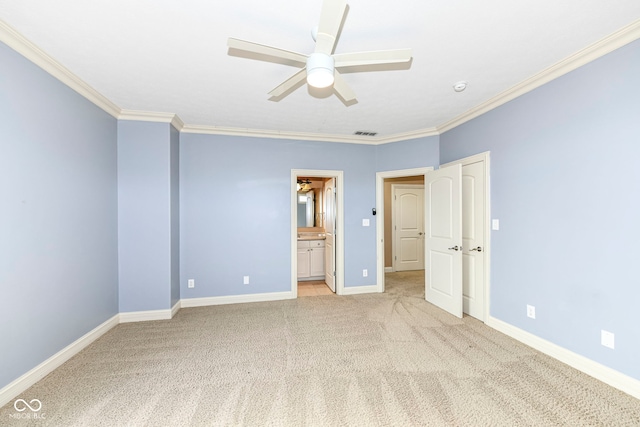 unfurnished bedroom with ornamental molding, ensuite bath, ceiling fan, and light colored carpet