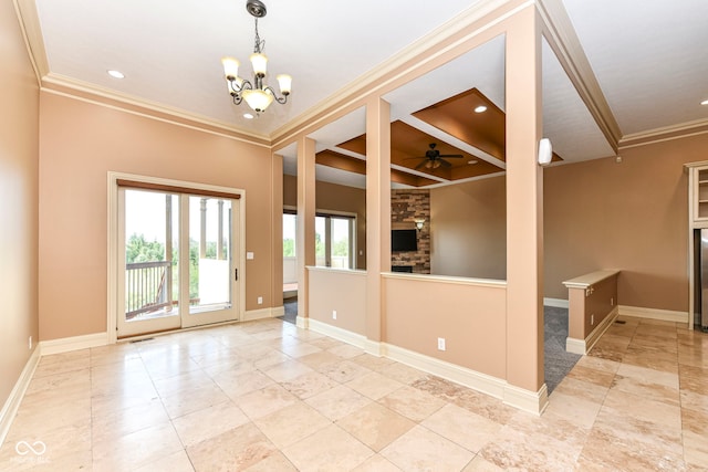 spare room with a fireplace, ceiling fan with notable chandelier, and ornamental molding