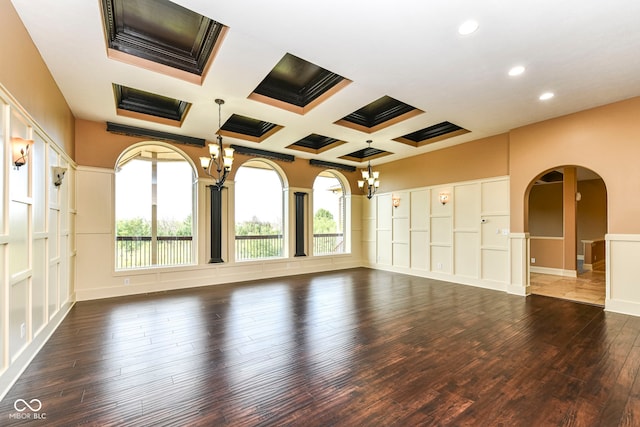 unfurnished room featuring coffered ceiling, beam ceiling, dark hardwood / wood-style flooring, and a healthy amount of sunlight