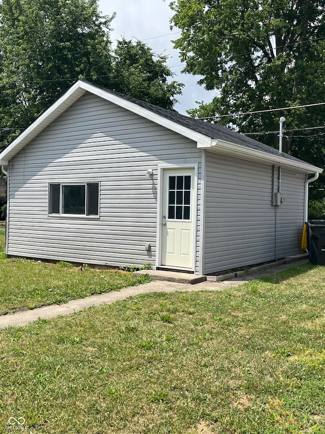 rear view of property featuring a lawn