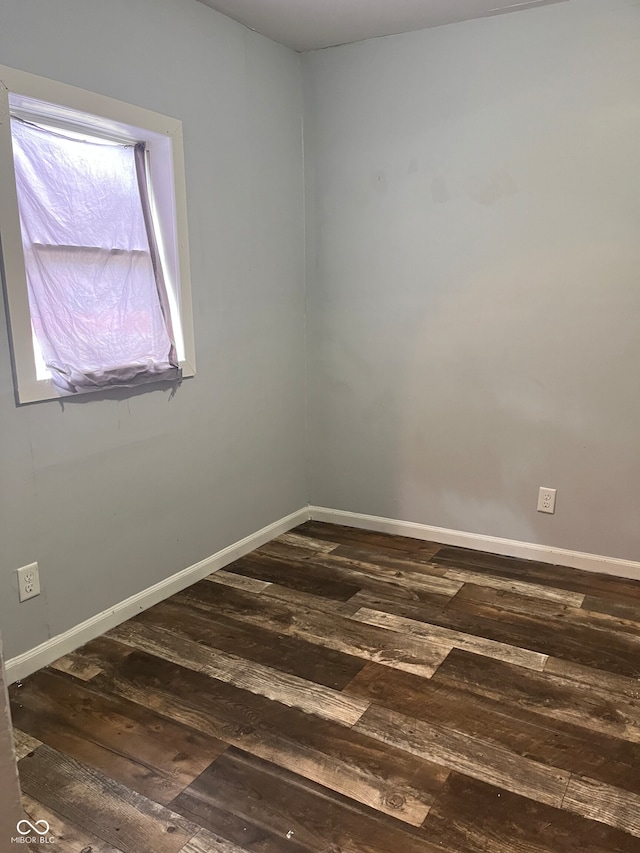 spare room featuring dark hardwood / wood-style floors