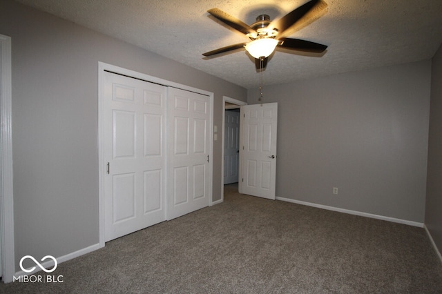 unfurnished bedroom with ceiling fan, carpet floors, a closet, and a textured ceiling