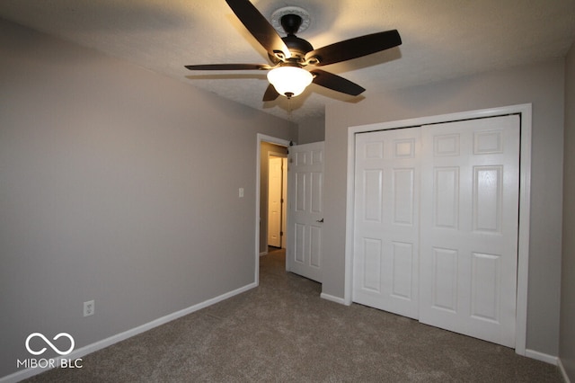 unfurnished bedroom with ceiling fan, carpet floors, and a closet