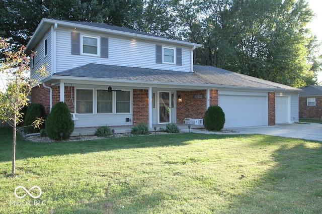 front of property with a garage, a front yard, and covered porch