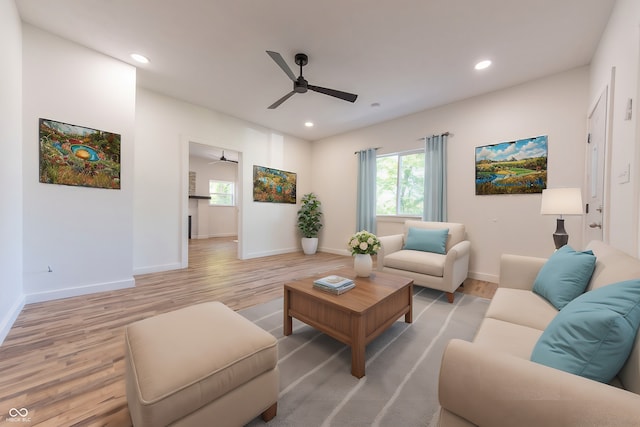 living room with ceiling fan and light hardwood / wood-style flooring