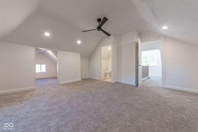 additional living space with light carpet, lofted ceiling, and ceiling fan