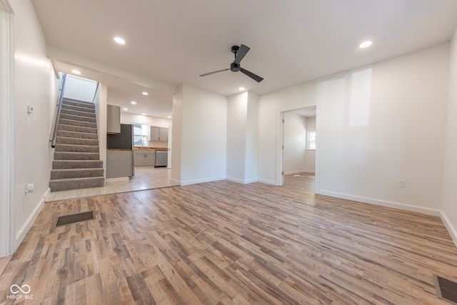 unfurnished living room featuring light hardwood / wood-style flooring and ceiling fan