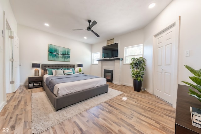 bedroom featuring a closet, light wood-type flooring, and ceiling fan