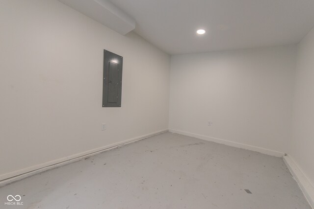 empty room with concrete floors and electric panel