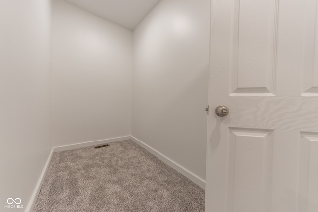 interior space featuring lofted ceiling and light carpet