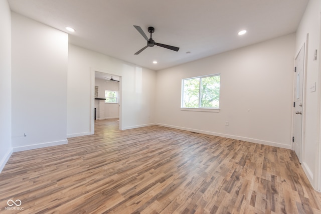 unfurnished room with ceiling fan and light wood-type flooring