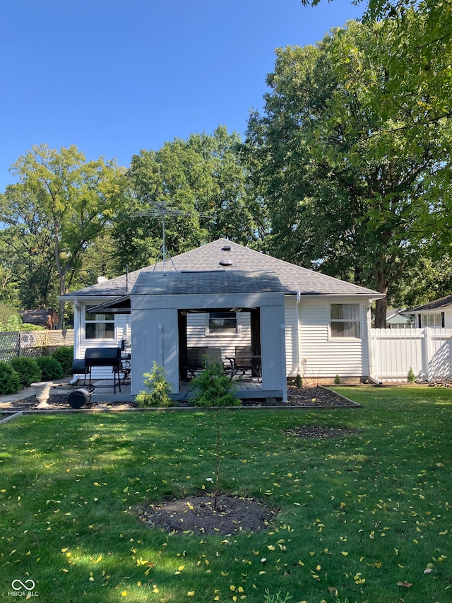 rear view of property featuring a lawn and a patio