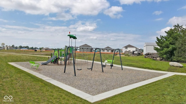 communal playground featuring a residential view and a yard